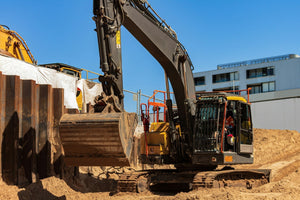 A construction site with a machine lifting a bucket